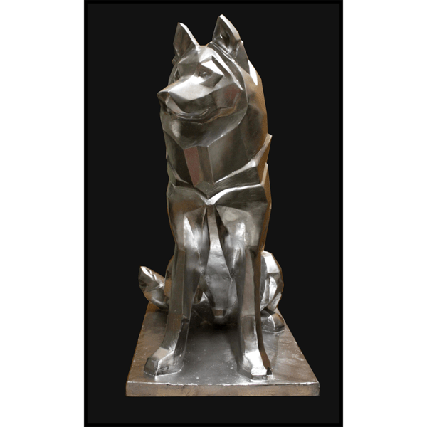 photo of aluminum-colored abstract sculpture of seated husky with black background