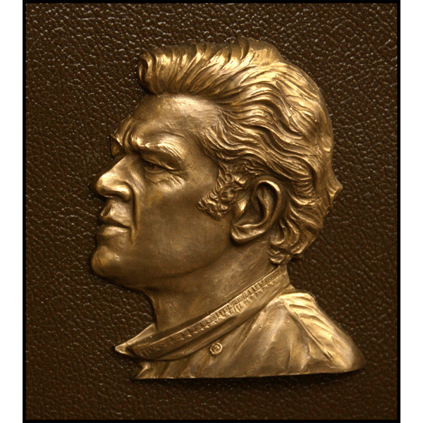 closeup photo of bronze-colored plaque with small relief portrait of Bob Jachowicz
