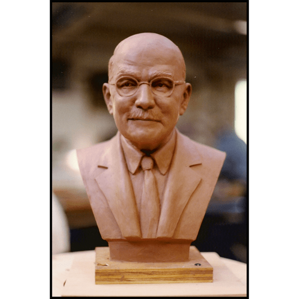 photo of clay model of sculpture bust of Donald Ross on wood blocks on wood work table
