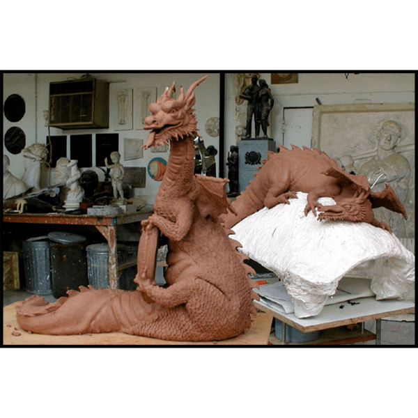 photo of two clay models of sculptures of dragons