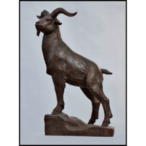 photo of bronze-colored sculpture of goat standing on sculpted incline