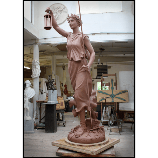 photo of clay model of statue of female representing Liberty with arm raised and holding lantern