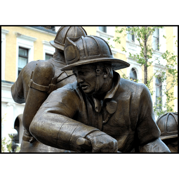 detail photo of bronze sculpture of firefighter in action stance