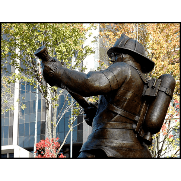detail photo of bronze sculpture of firefighter in action stance