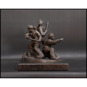 photo of bronze-colored sculpture of three firefighters in action stances on a stone base