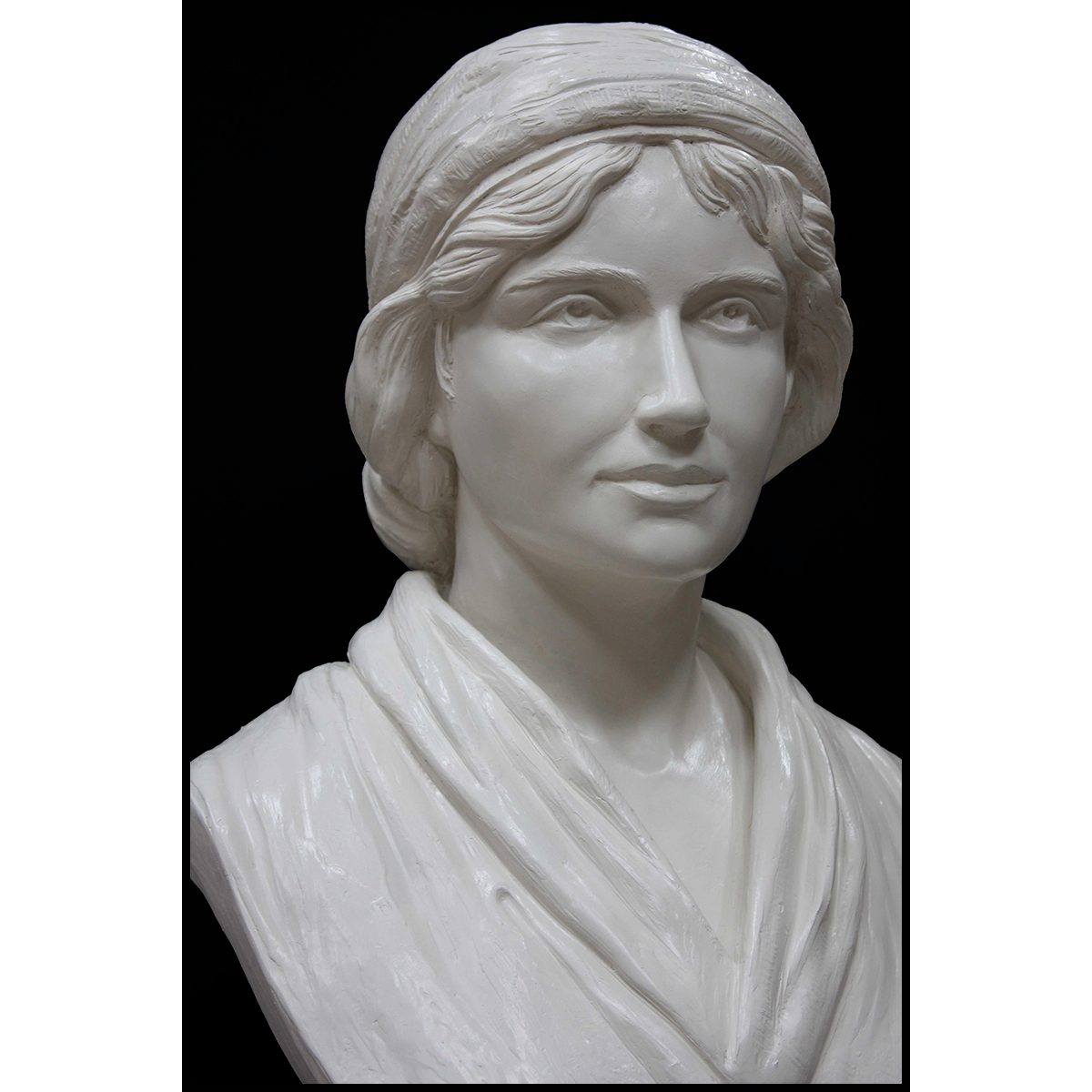 detail of white plaster bust of female, namely Mary Wollstonecraft, against gray background
