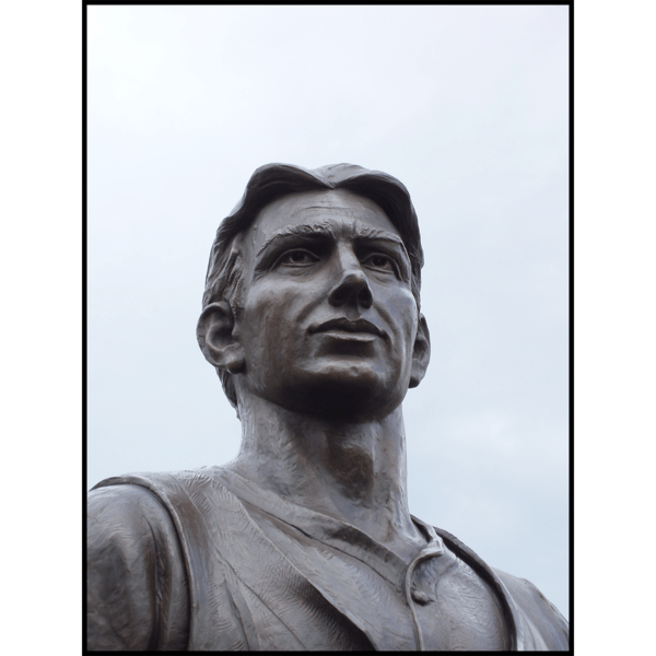 photo closeup of bronze sculpture of male figure's face