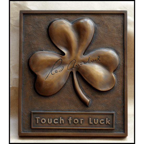 bronze relief sculpture of shamrock with Red Auerbach's signature