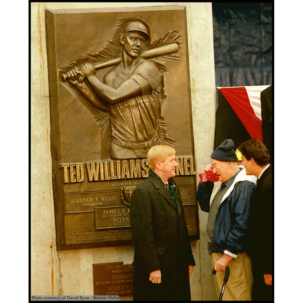 photo of bronze relief of Ted Williams batting with people at dedication
