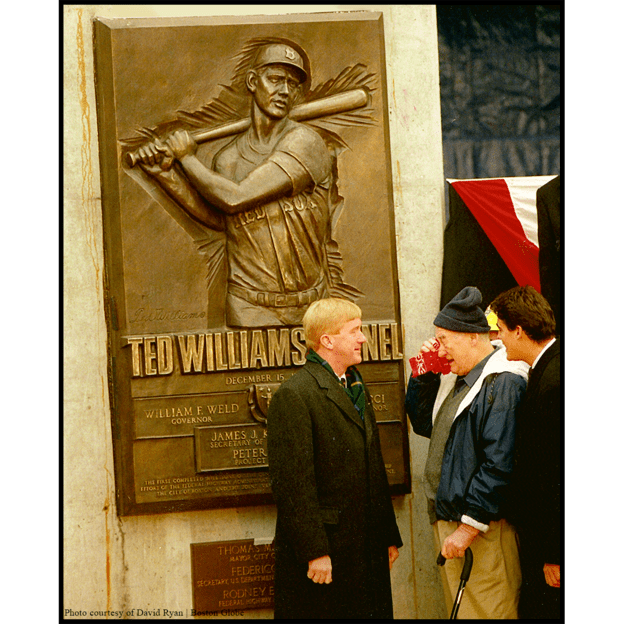 photo of bronze relief of Ted Williams batting with people at dedication