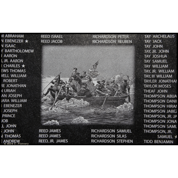 photo closeup of black granite etchings on war memorial wall of veterans' names and image of painting of Washington Crossing the Delaware by Emanuel Leutze
