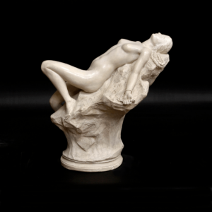 photo of white-colored Andromeda reduction sculpture featuring a female laying with her back against a rock