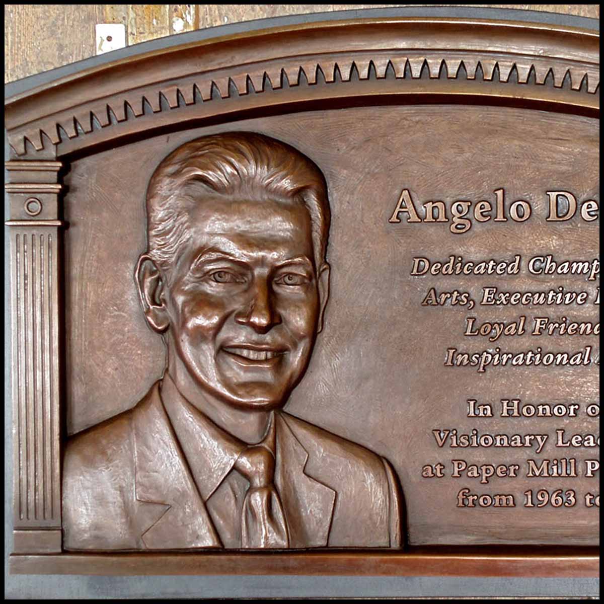 photo of bronze-colored relief plaque of bust of Angelo Del Rossi