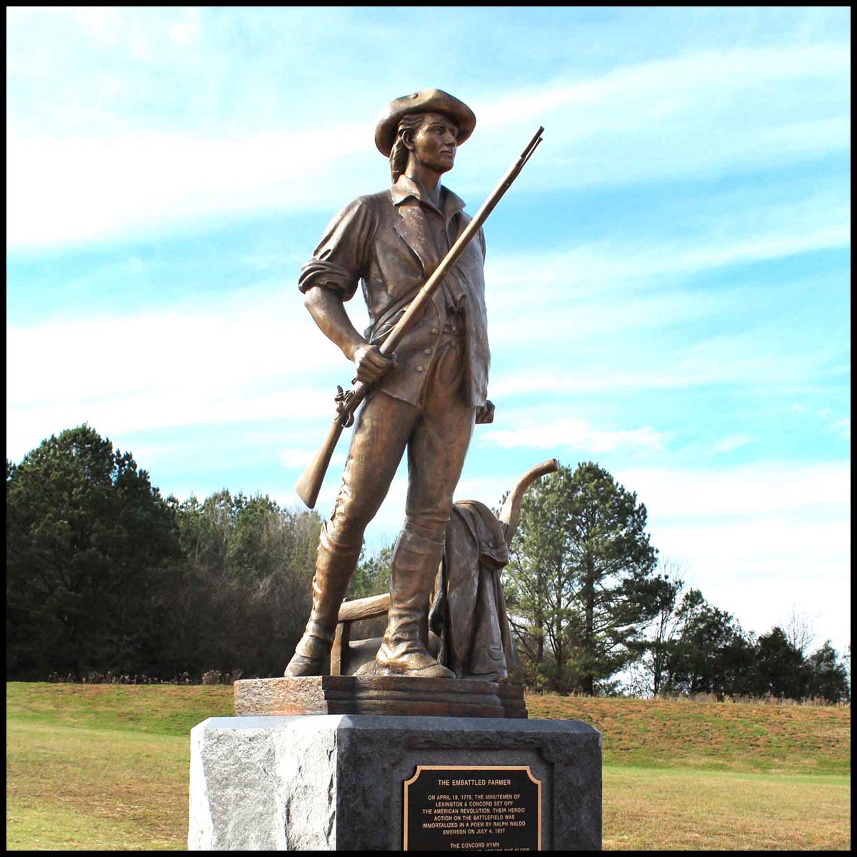 exterior photo of bronze sculpture of Minuteman on stone base