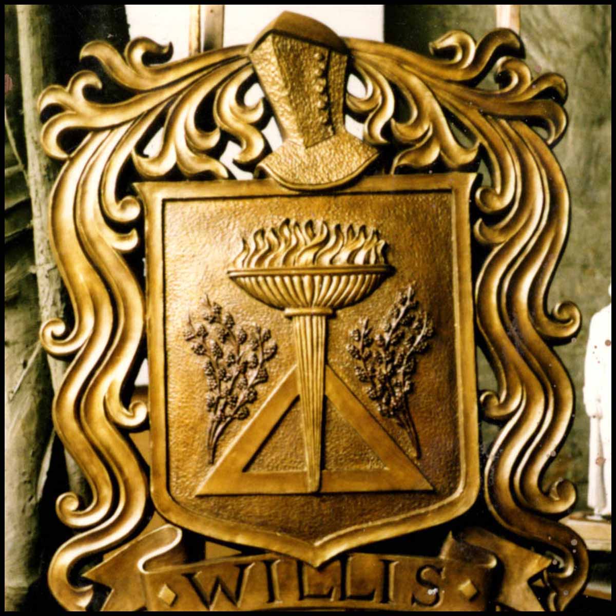 photo of bronze relief cartouche of family seal on wood easel