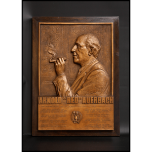 photo of bronze plaque of Red Auerbach profile on a wood mount