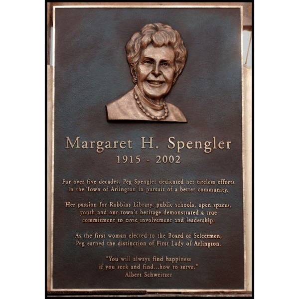 photo of bronze-colored plaque with portrait bust in relief of Margaret Spengler in sculptor's studio